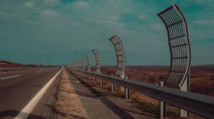 Illustration of the barren landscape and empty tree guards along the A14 bypass, highlighting the environmental impact (AI-generated, non-realistic illustration). Credit: Ideogram.